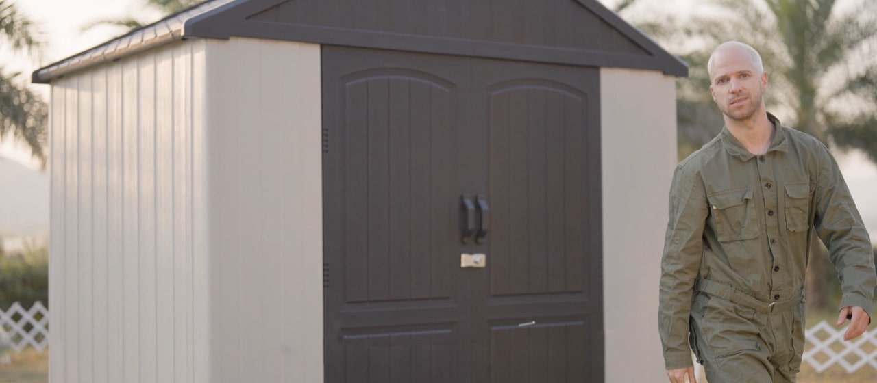 a man standing in front of 8x6 plastic storage shed