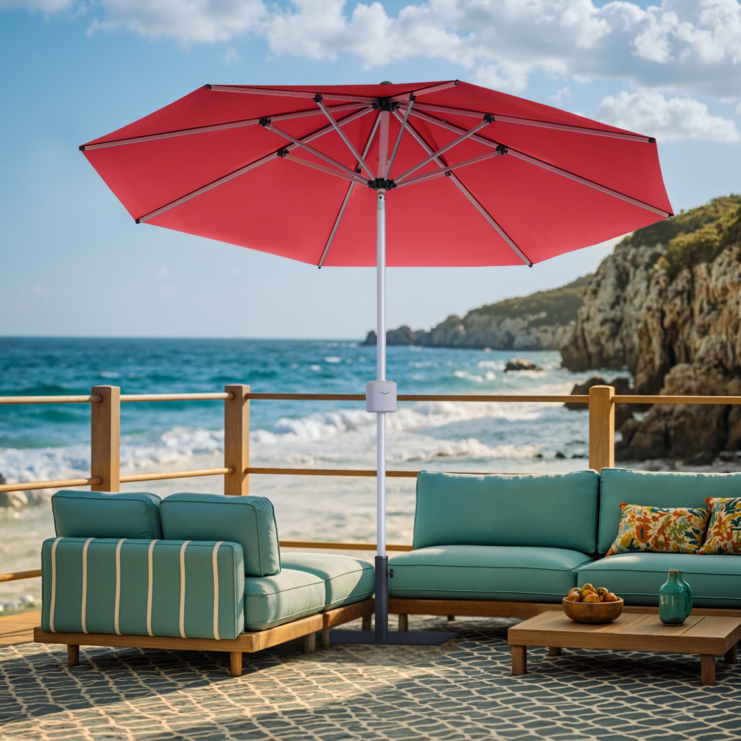 Outdoor patio set with teal furniture and red umbrella by the ocean.