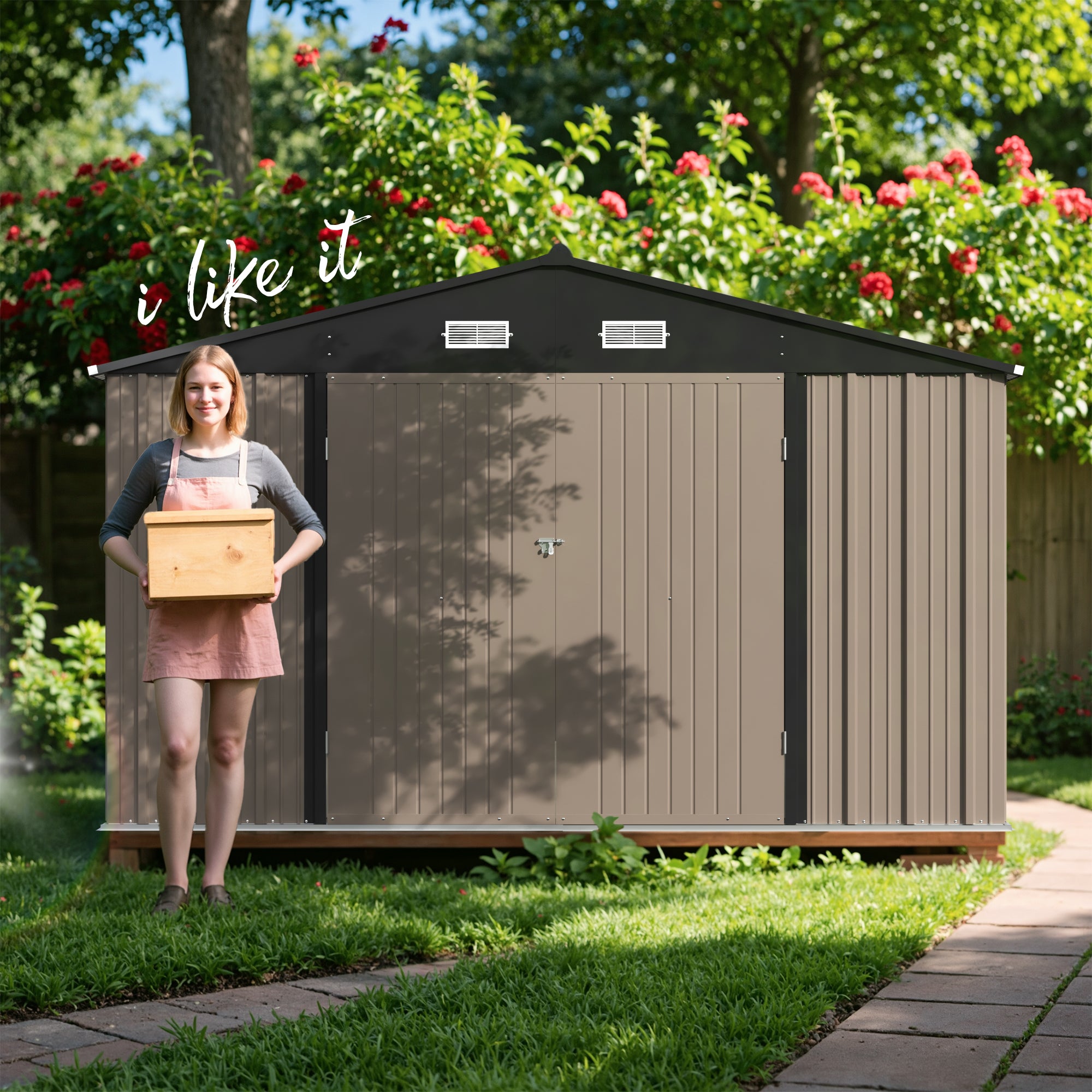 Woman holding a box in front of a garden shed with flowers and trees in the background