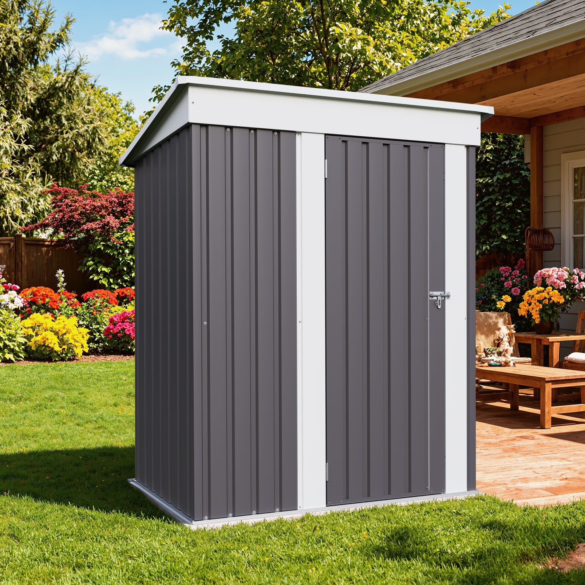 5x3 Gray metal storage shed in a garden setting with flowers and a wooden deck.