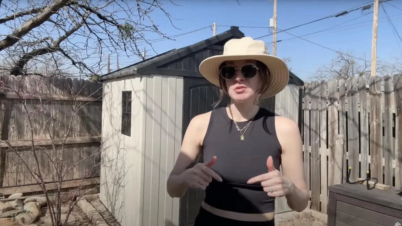 a lady stangding in front of 8x6 plastic storage shed